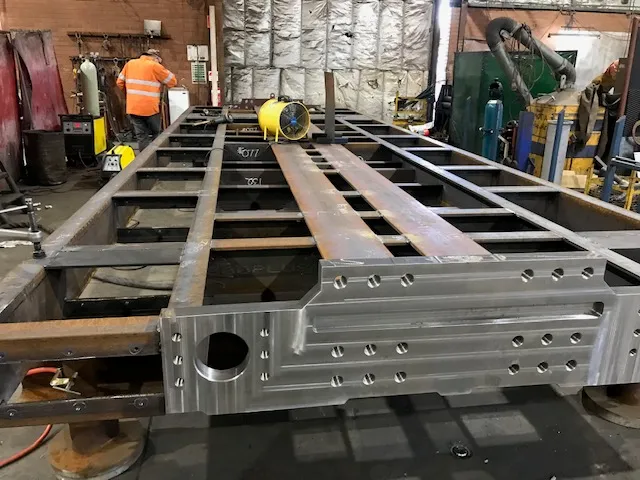 A large fabricated steel frame on the workshop floor